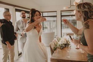 A bride and guest share a fun moment during the wedding celebration.