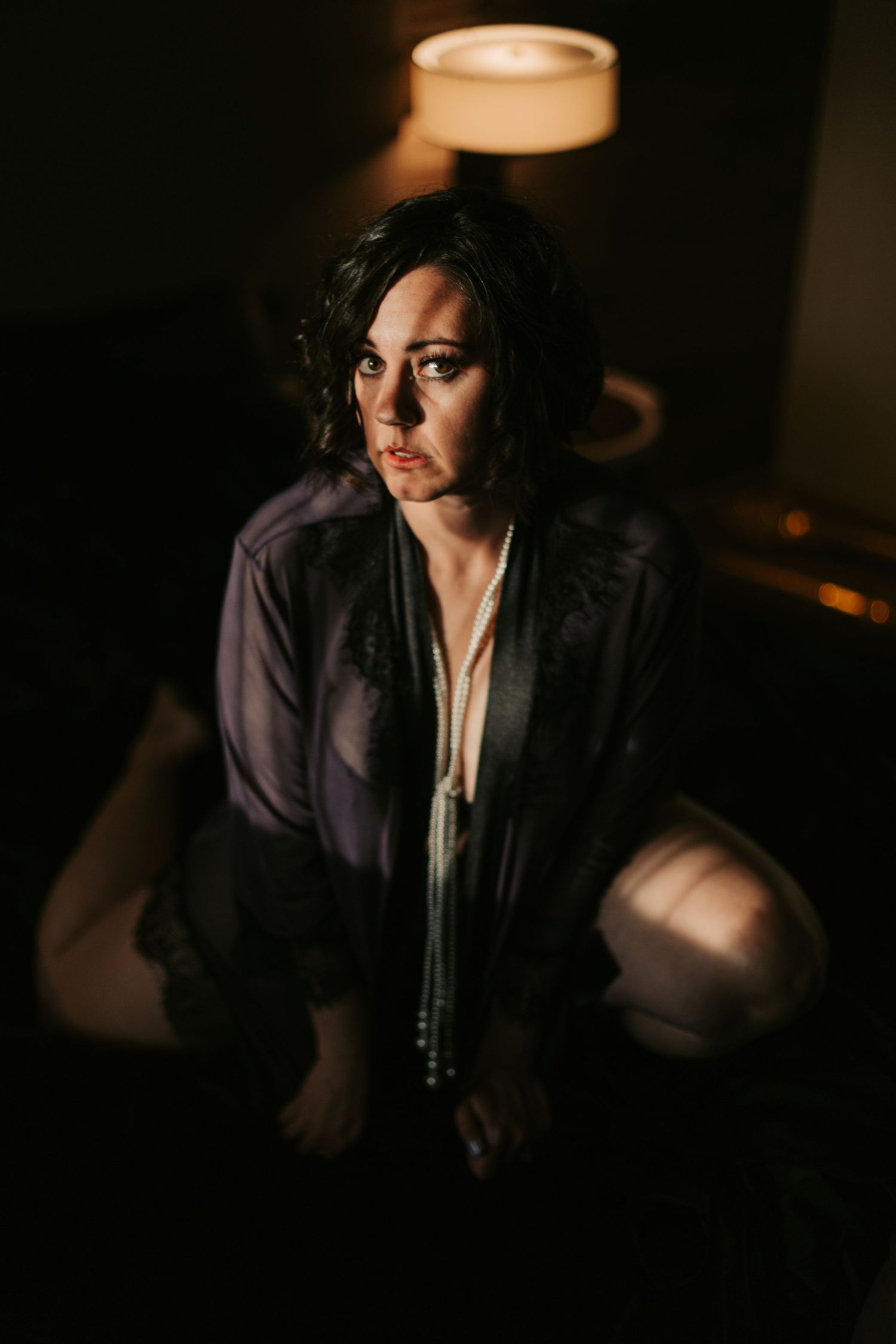 Dark and atmospheric portrait in vintage noir style with dramatic lighting.