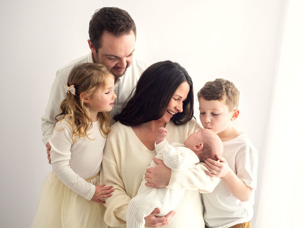 A young couple with their two children and newborn baby, have a photoshoot in Didcot with Verity Photography