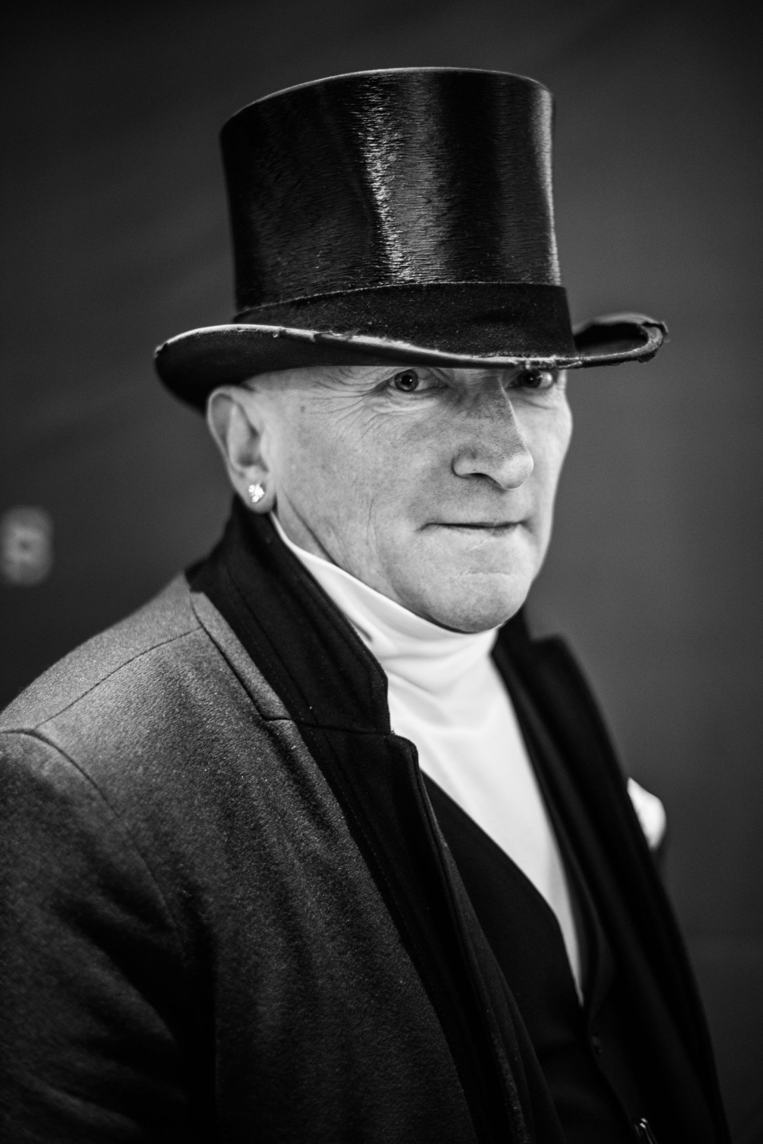 Black & White Portrait of a Stranger: A man wearing a topcoat and evening coat in London's Shoreditch neighborhood