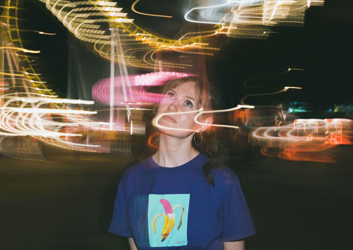 Abstract nighttime portrait with light trails creating dreamy motion effects.