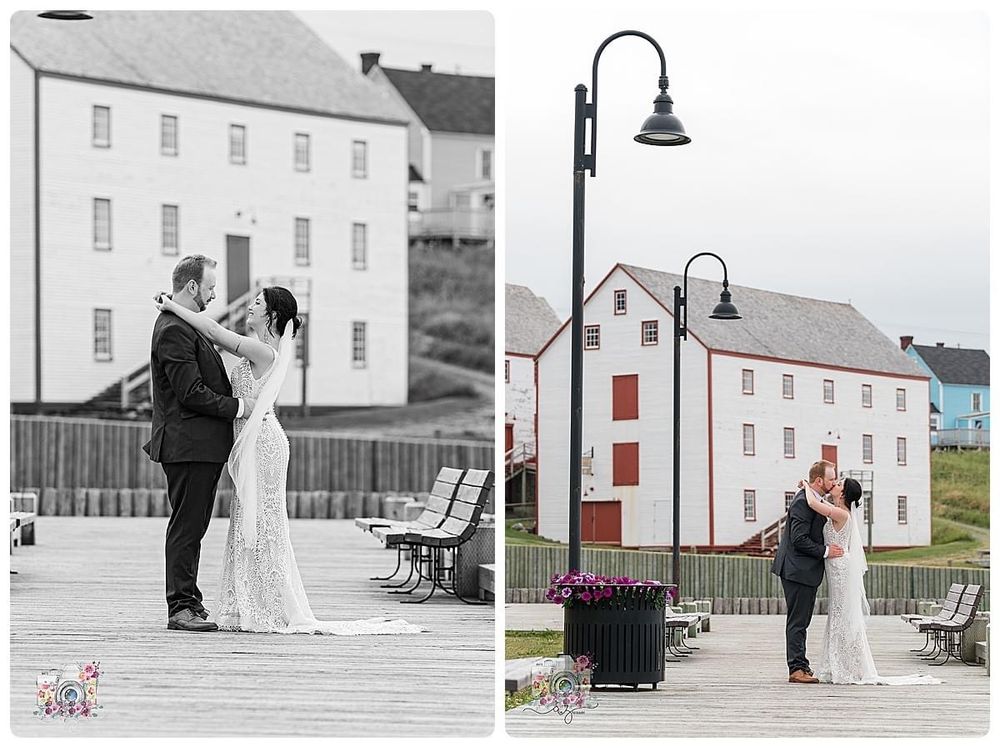 Wedding couple poses in front of historic white buildings with street lamps in black and white.