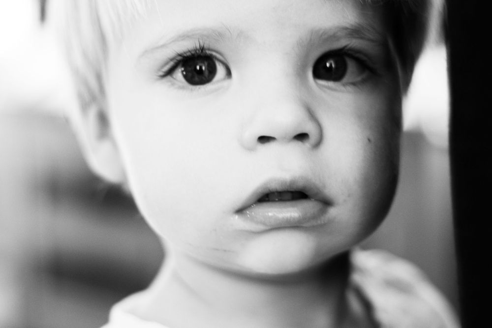 Black and white image of a young blond child