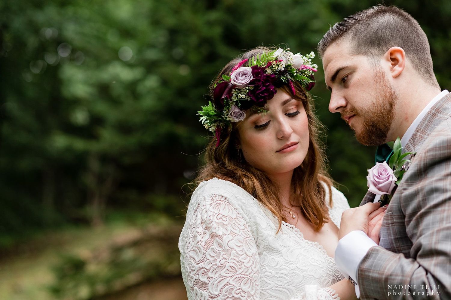 A romantic woodland wedding moment featuring floral crown and intimate embrace.