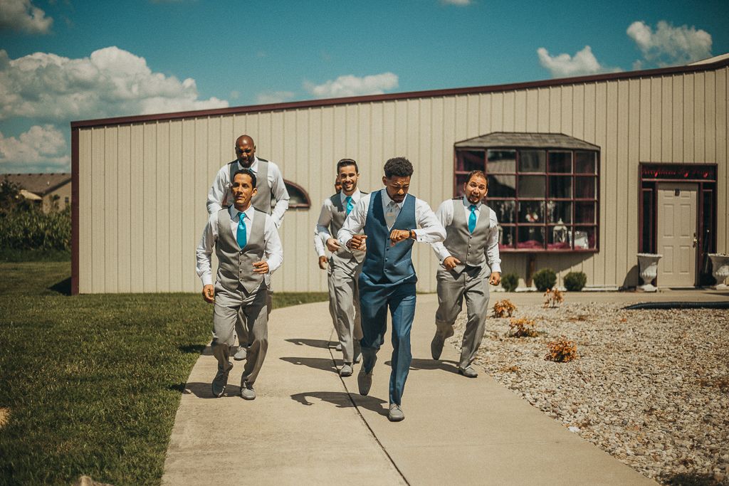 groomsmen running towards the altar