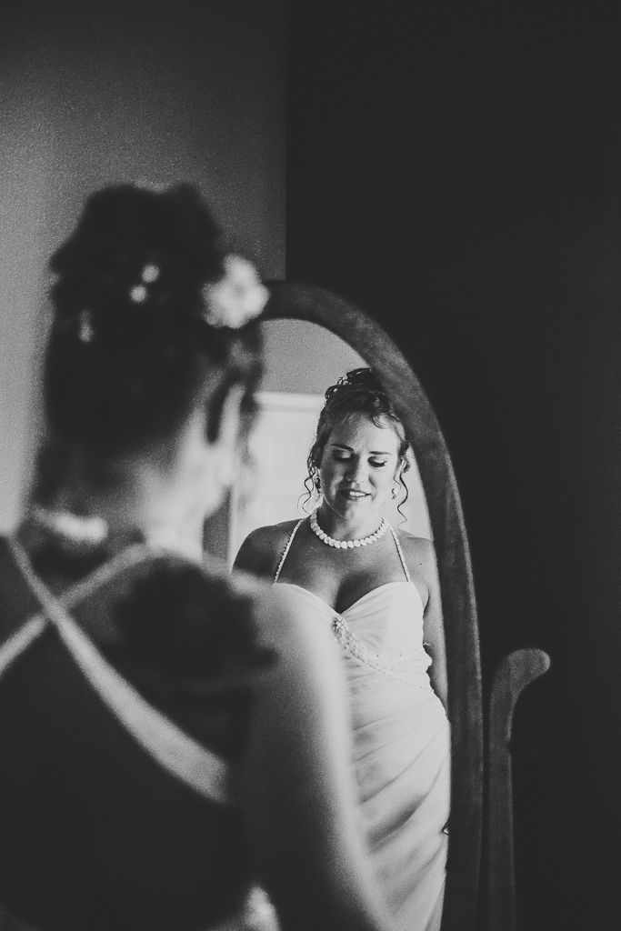 Bride looking at herself in the mirror