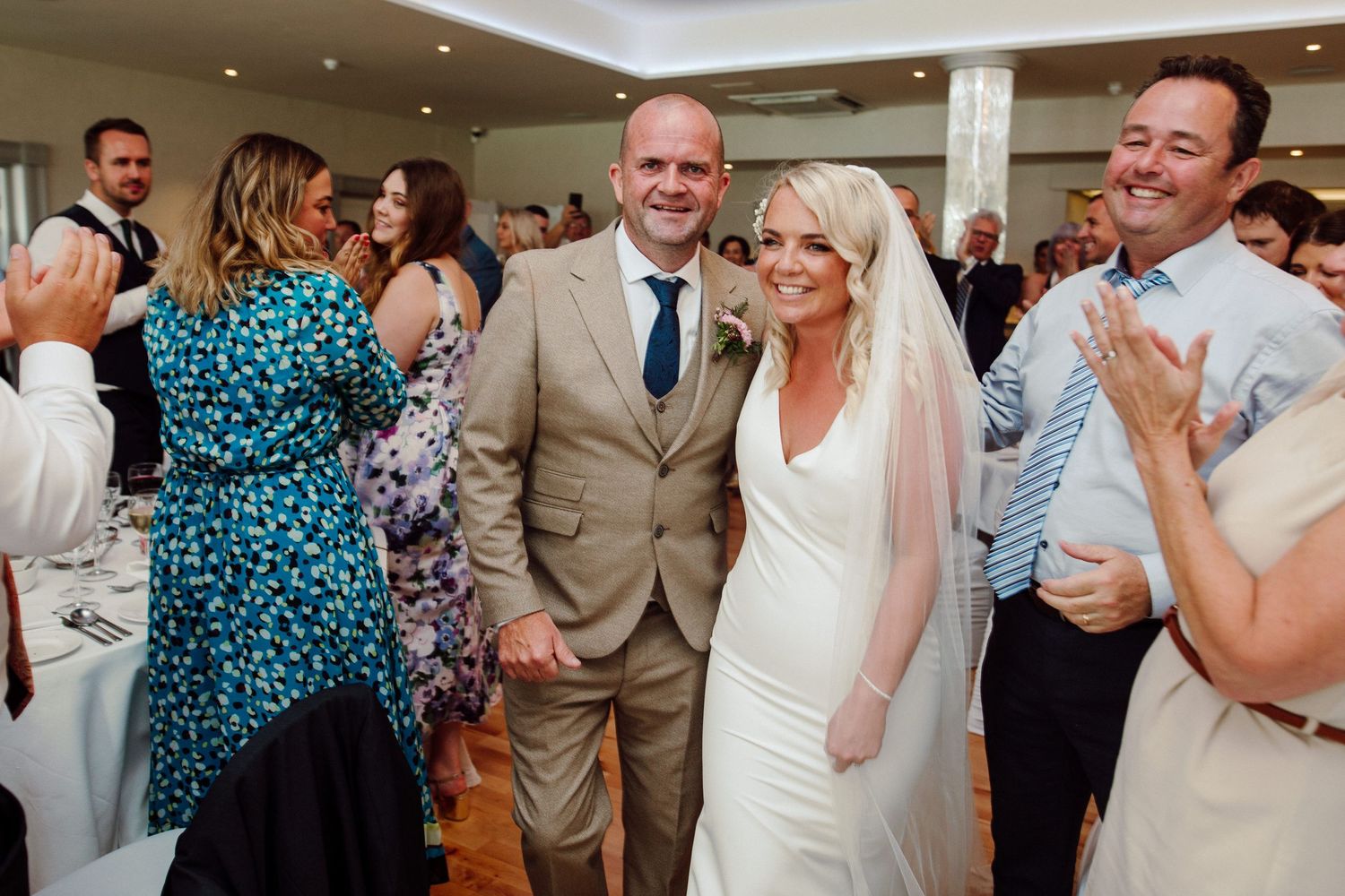 Newlyweds share a joyful moment with guests during their wedding reception.