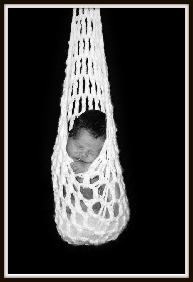 Series of black and white photos showing a small figure suspended in a white macrame cradle.