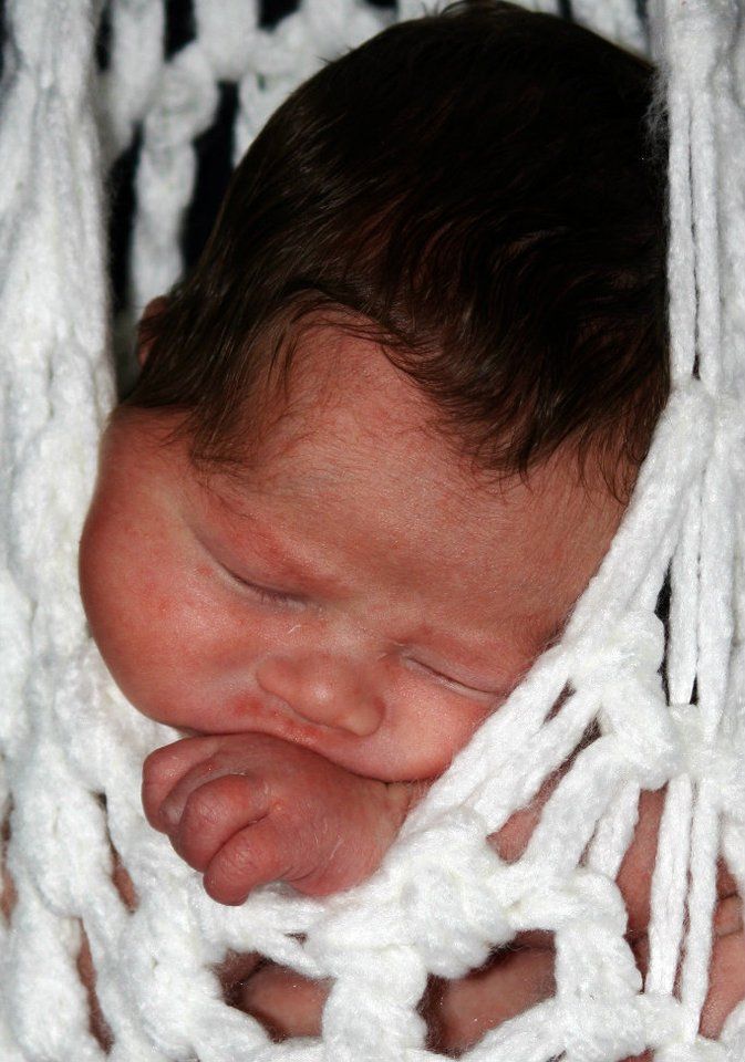 Close-up black and white portrait series showing peaceful sleeping newborn.