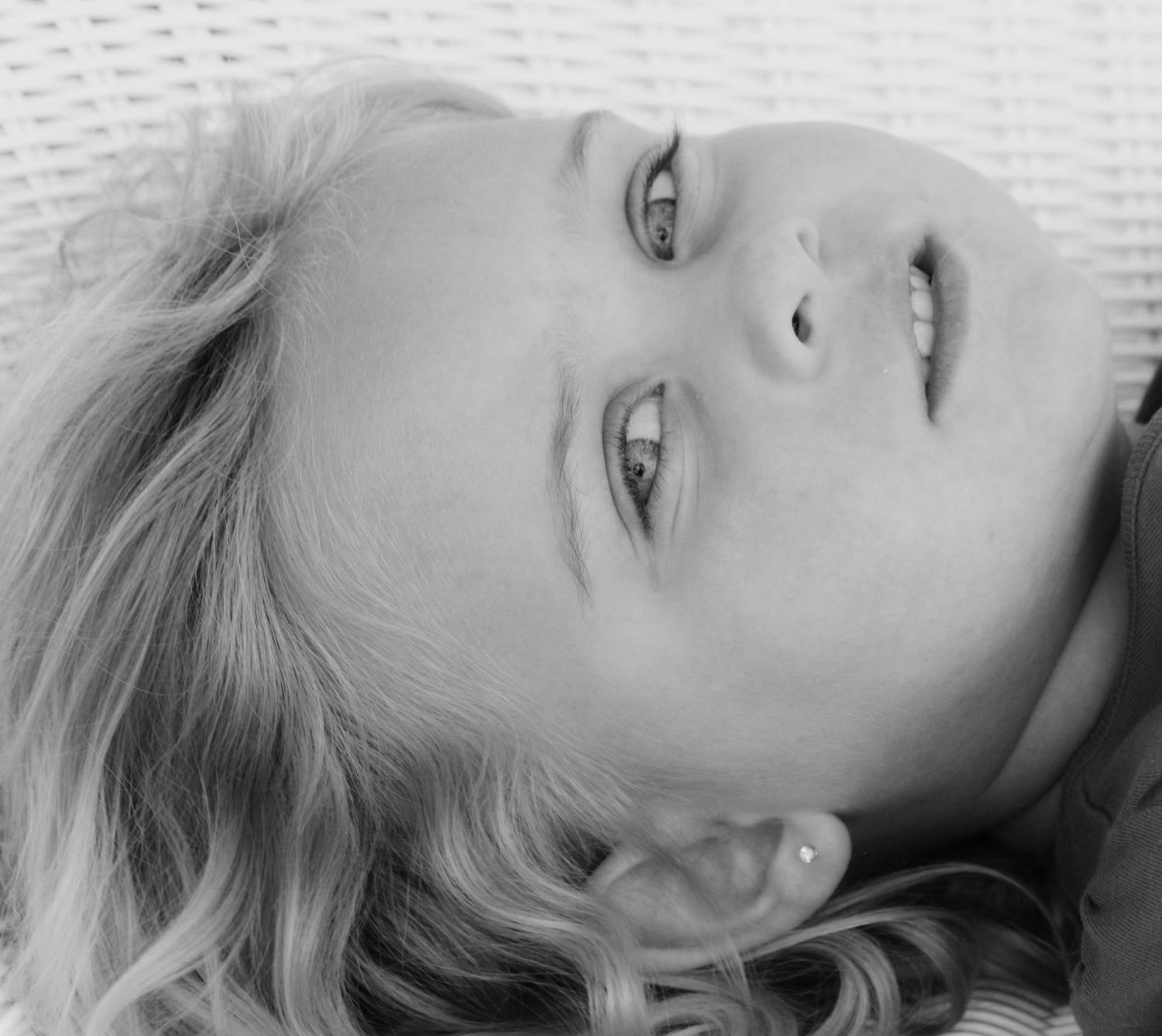Series of artistic black and white close-up portraits on white textured background.