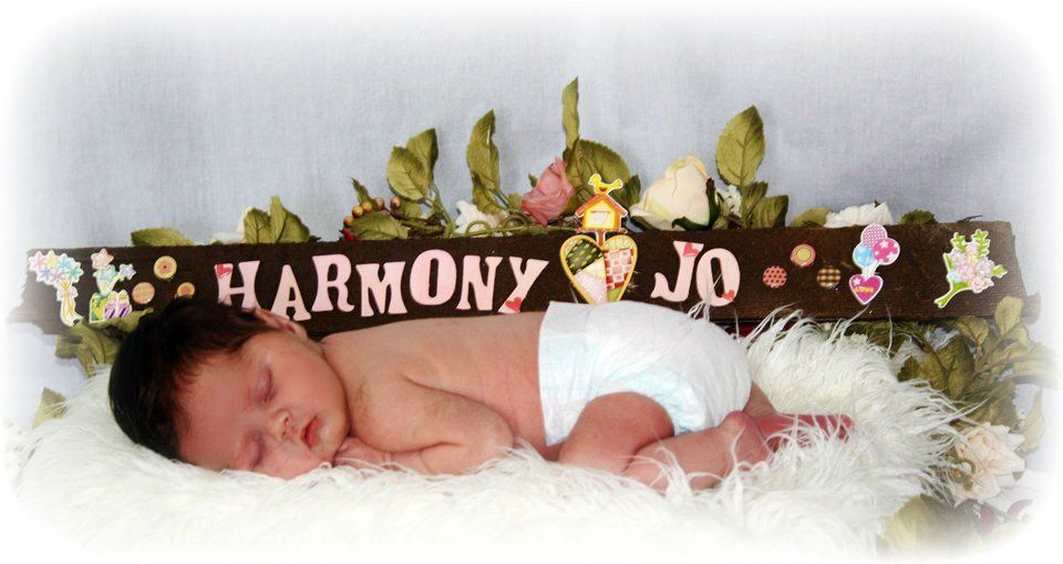 Decorative banner with floral and woodland animal designs in soft pastel colors.