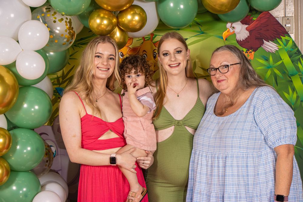 Safari-themed baby shower with balloon arch and decorative backdrop featuring jungle animals.