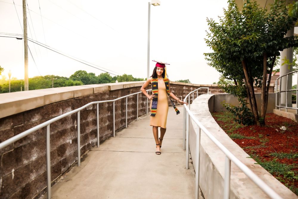 african american girl in gold dress and graduation outfit on the campus of Tuskegee University