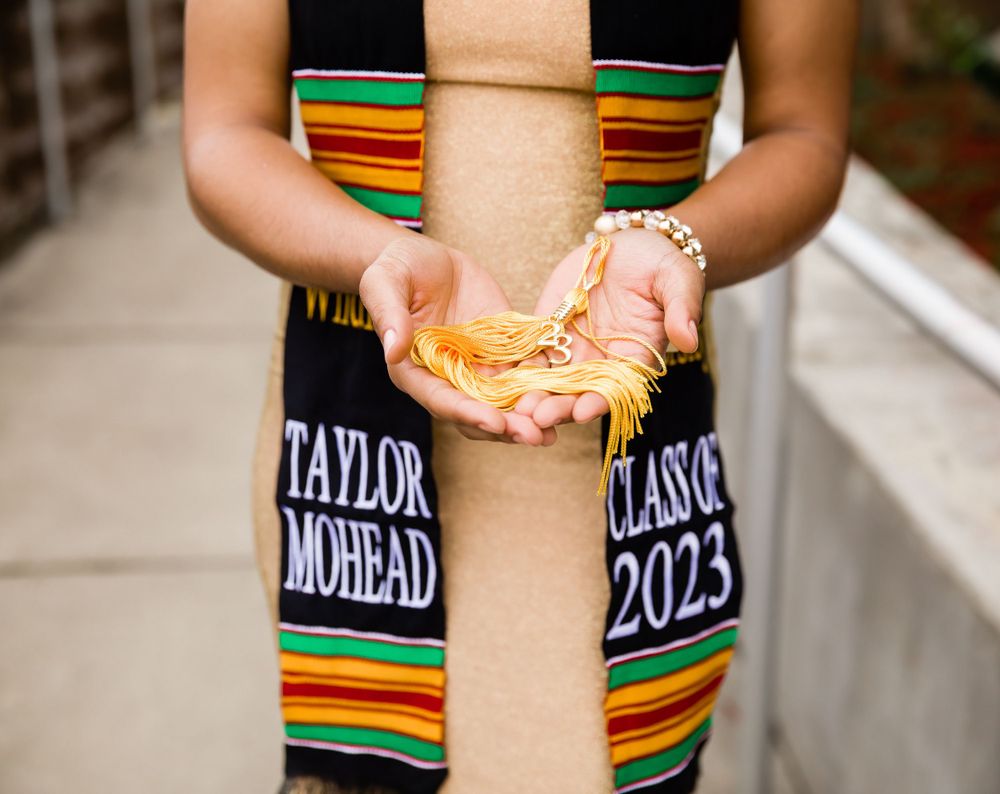 graduation tassel held by a female on the campus of Tuskegee University