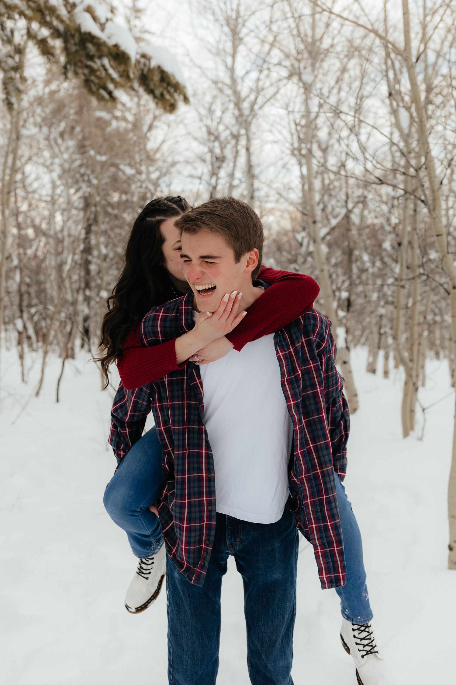 Engaged couple Piggy Back Bride Kissing Cheek