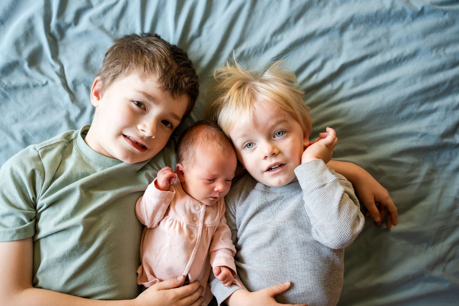 two brothers with new baby sister