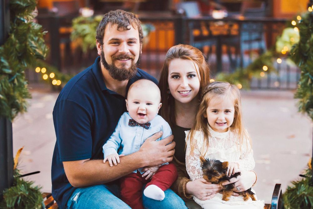 A beautiful family is posing for a their Christmas photo in Knoxville TN