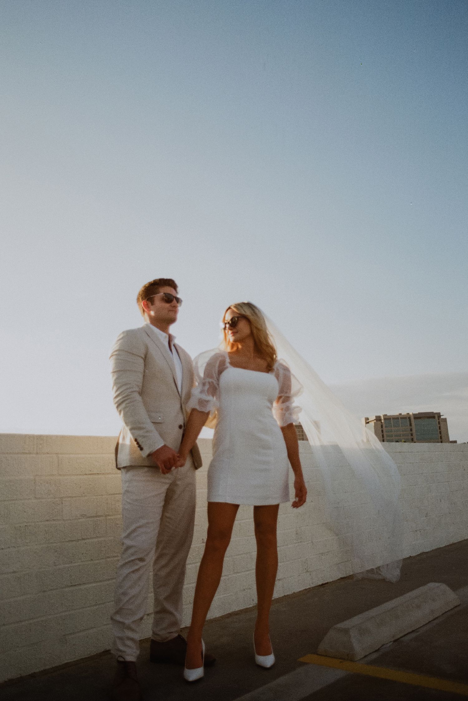 35mm film photo of fun bridal themed engagement shoot on roof of parking structure in Lido Marina, Newport beach