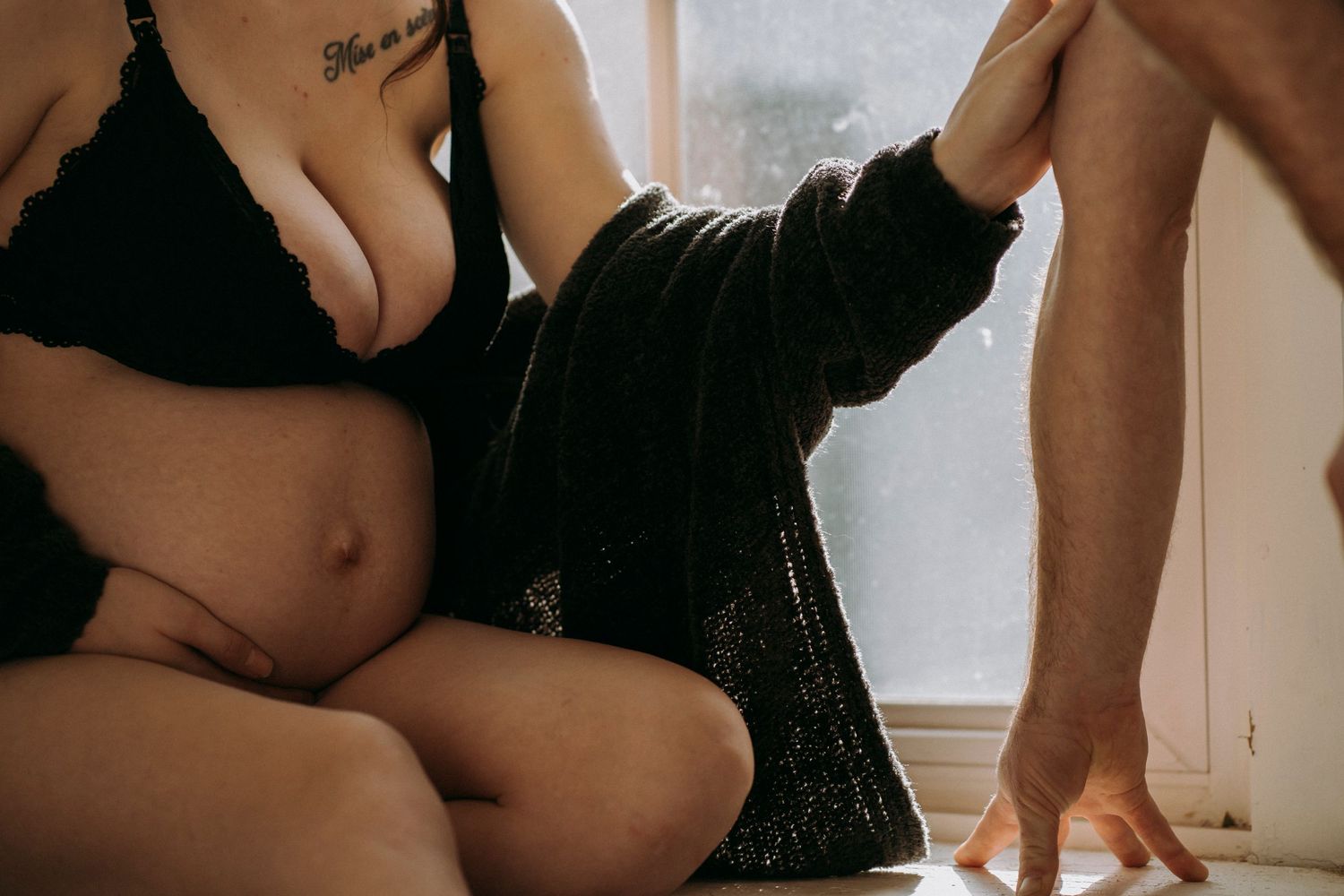 Artistic boudoir photography with minimalist window lighting and intimate composition.