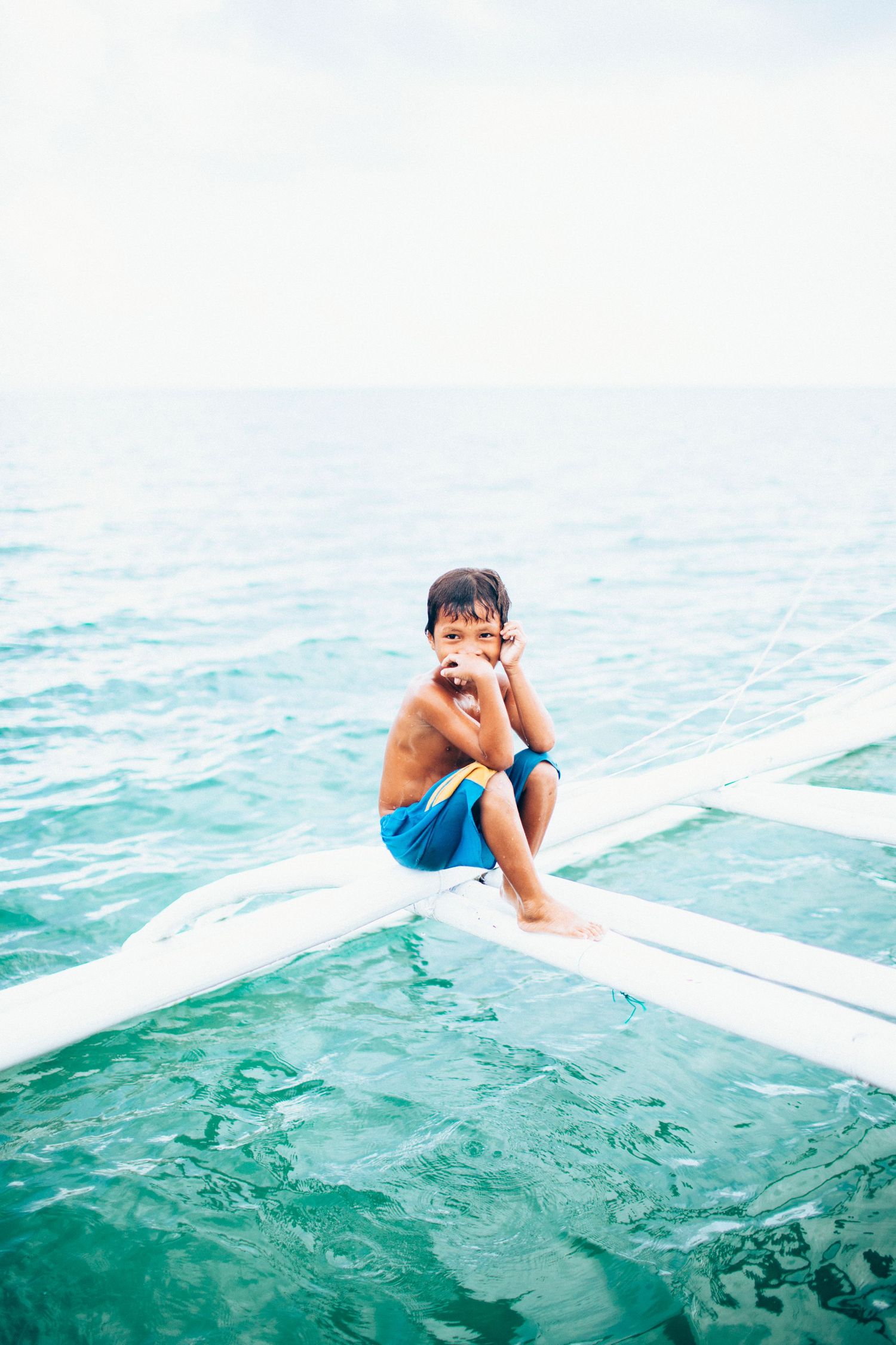 Filipino boy sitting on boat in Cebu, Philippines