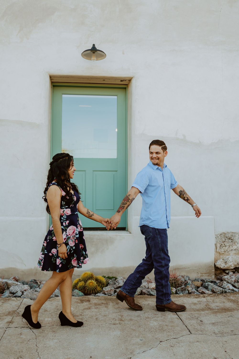 People playfully pose against a white wall with mint green door frames in an artistic sequence.