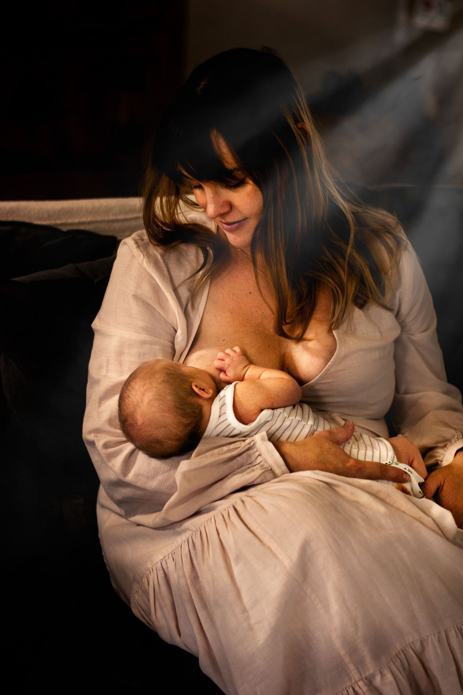 Mother breastfeeding newborn baby in lifestyle session Dubbo Photographer