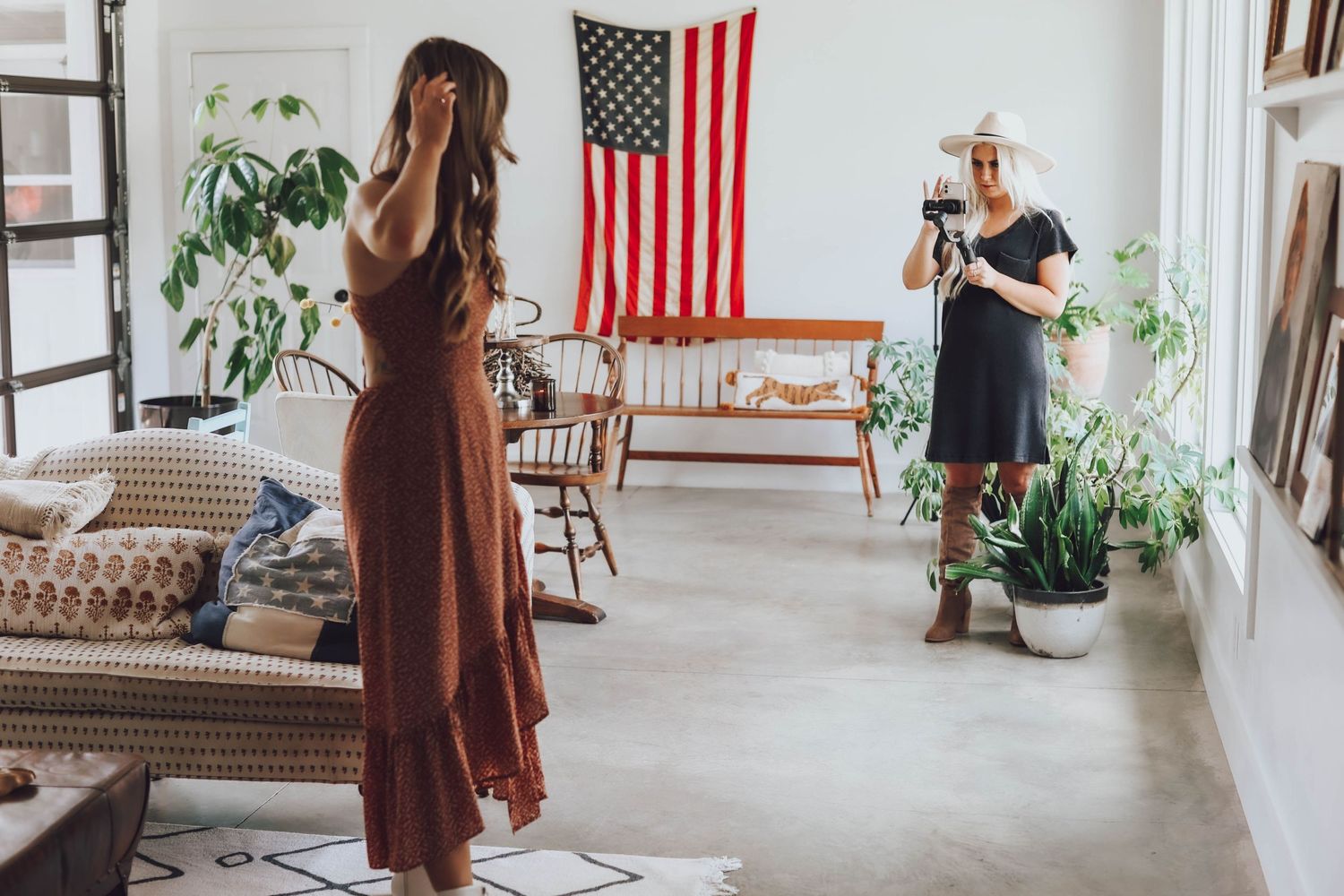 Group photo session in spacious room with American flag and brown furniture.