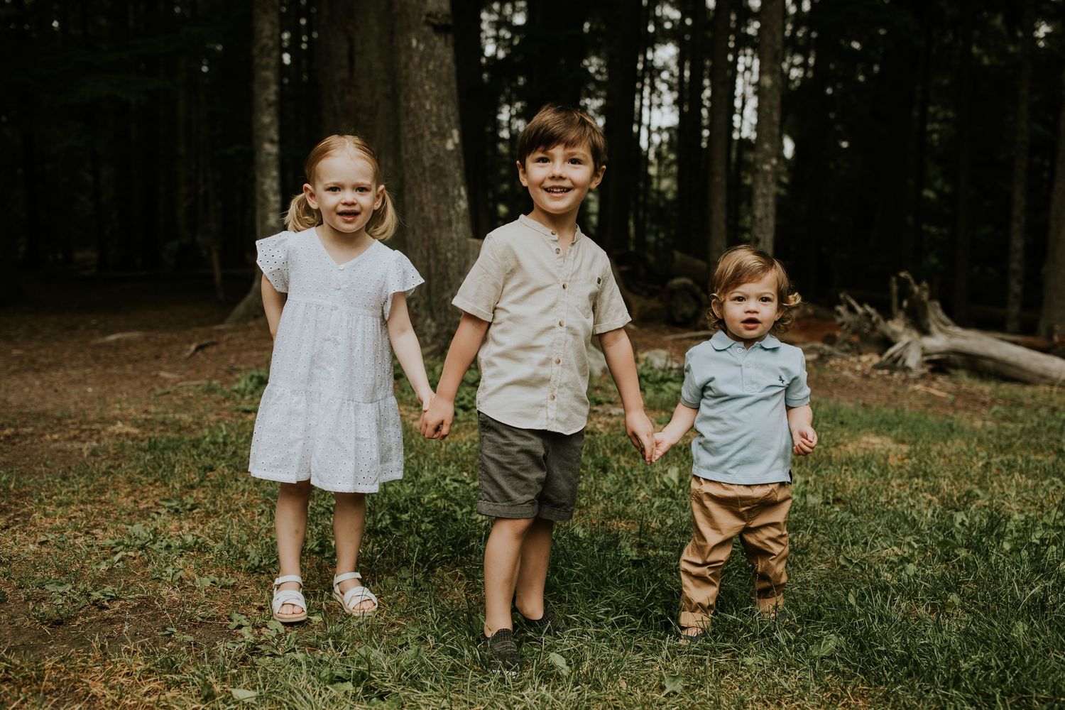 Three young kids hold hands at Rebagliati Park.