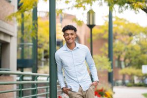 Casual outdoor portraits taken in an urban setting with yellow fall foliage.