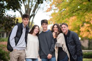Group of friends laughing together outdoors during autumn season.
