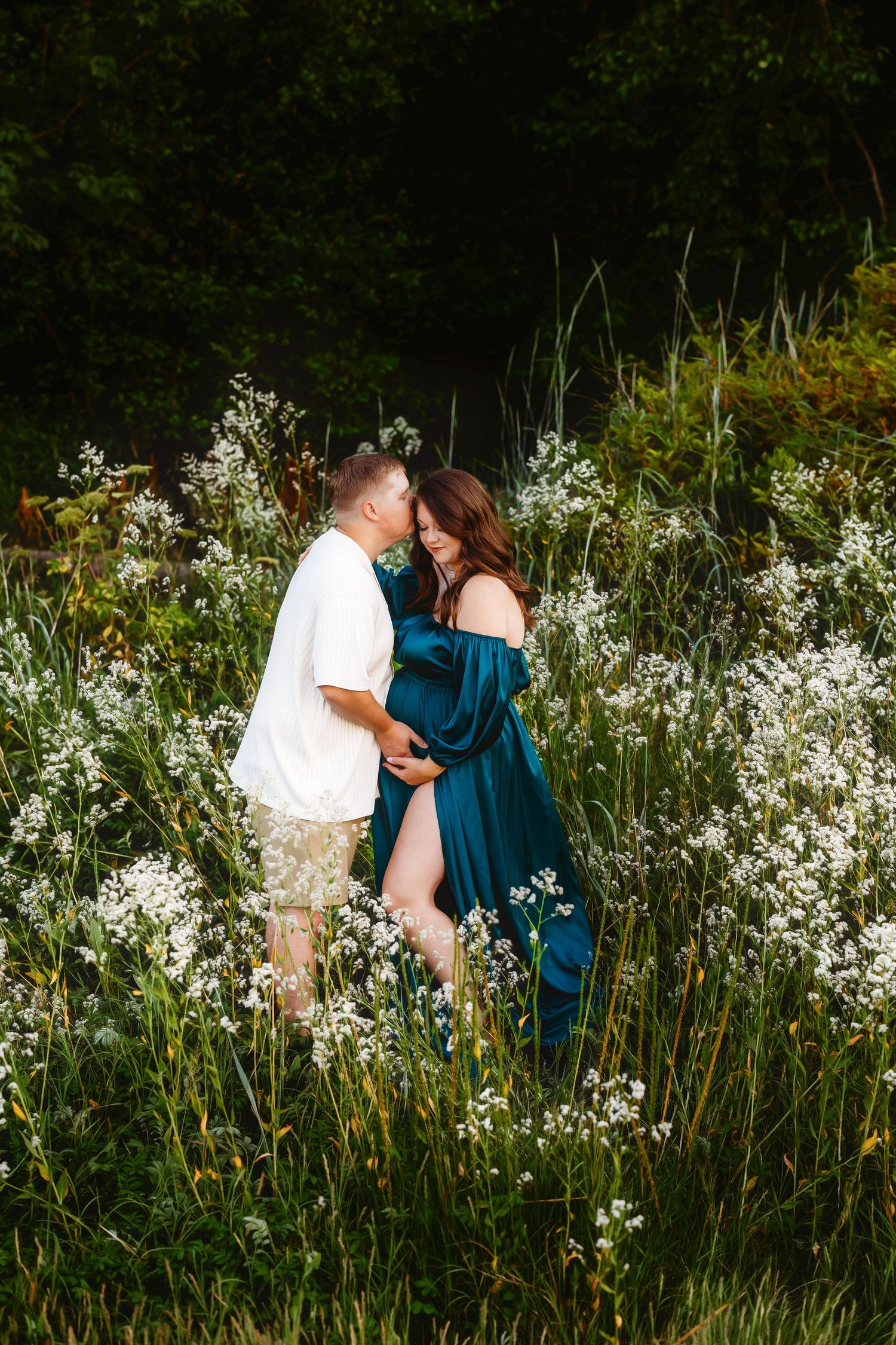 maternity session in a field of white flowers
