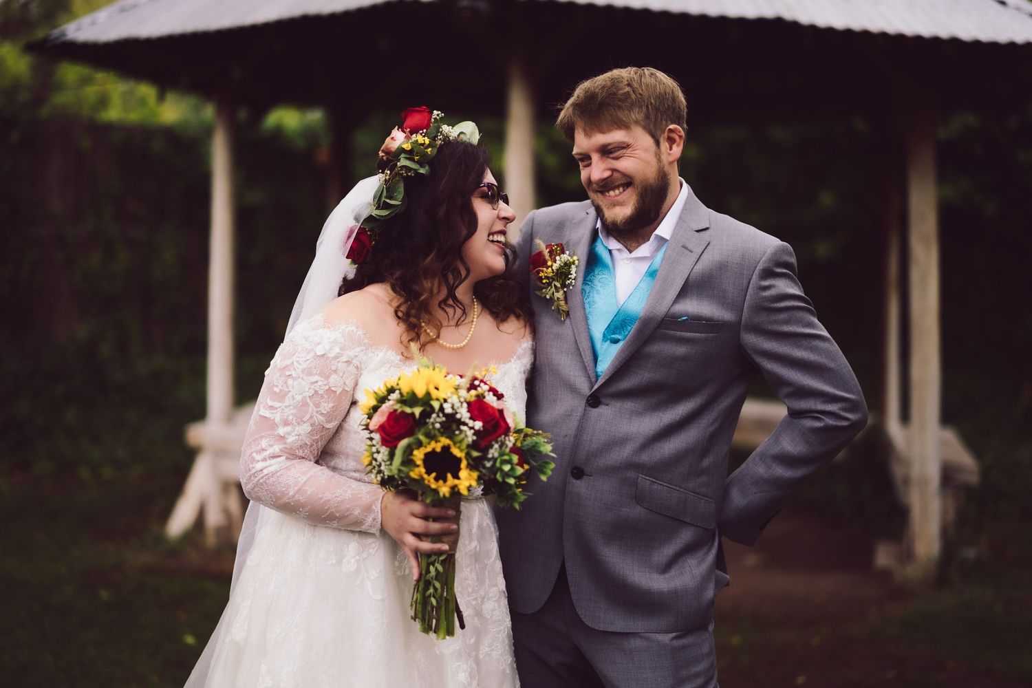 Bride with bouquet smiling at groom