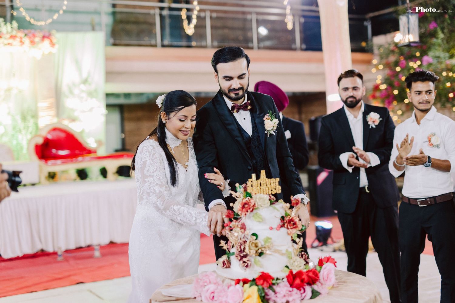 Wedding party members celebrating with confetti and laughter during an elegant indoor reception.