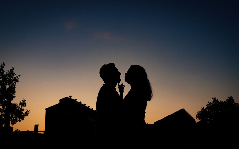Silhouettes against a dusky blue sky during sunset.