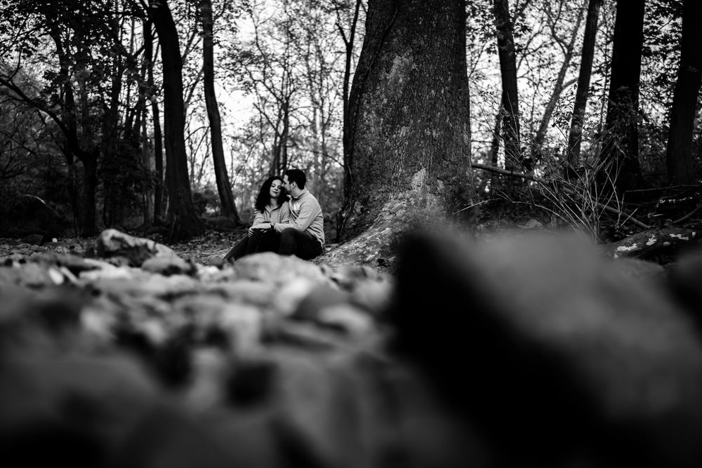 Black and white silhouette portrait of a couple in a wooded setting.
