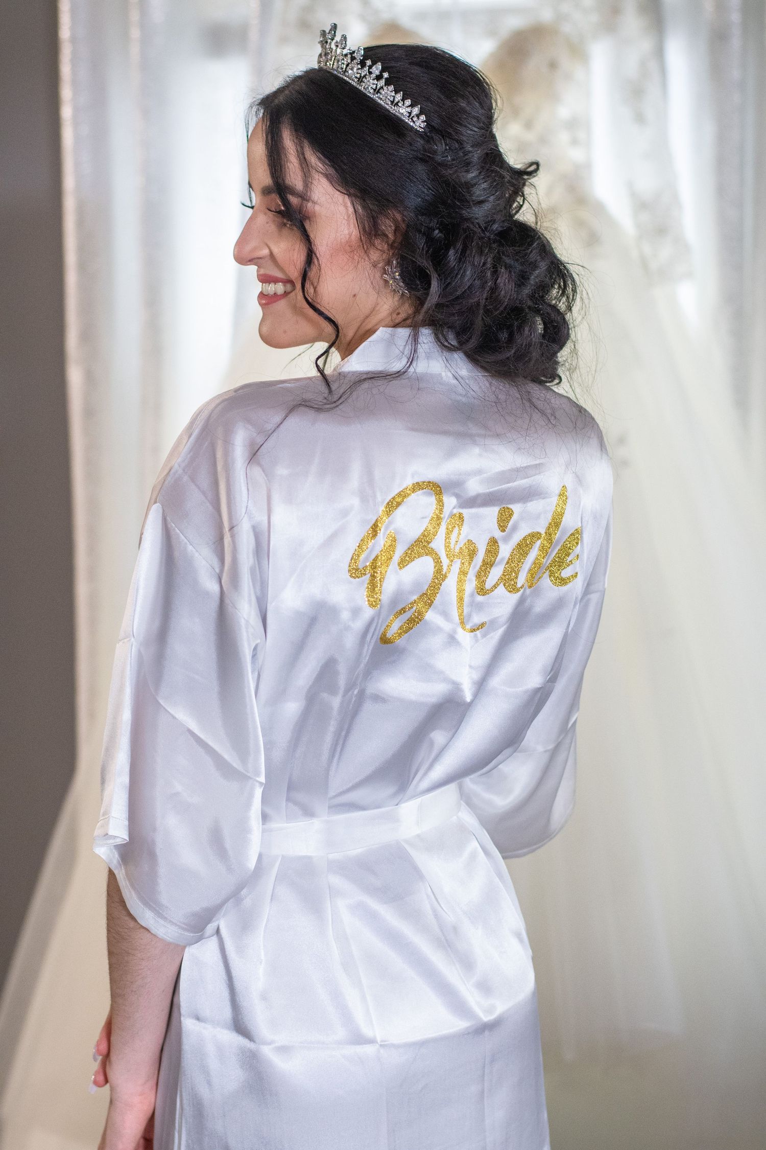 Silk bridal robe with gold 'Bride' lettering shown from behind with delicate crown detail.