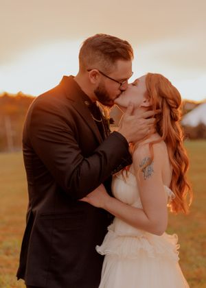 Romantic sunset wedding portrait in golden hour lighting.