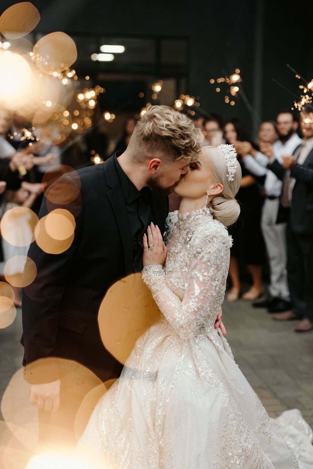 Bride and groom kissing at their sparkler send off