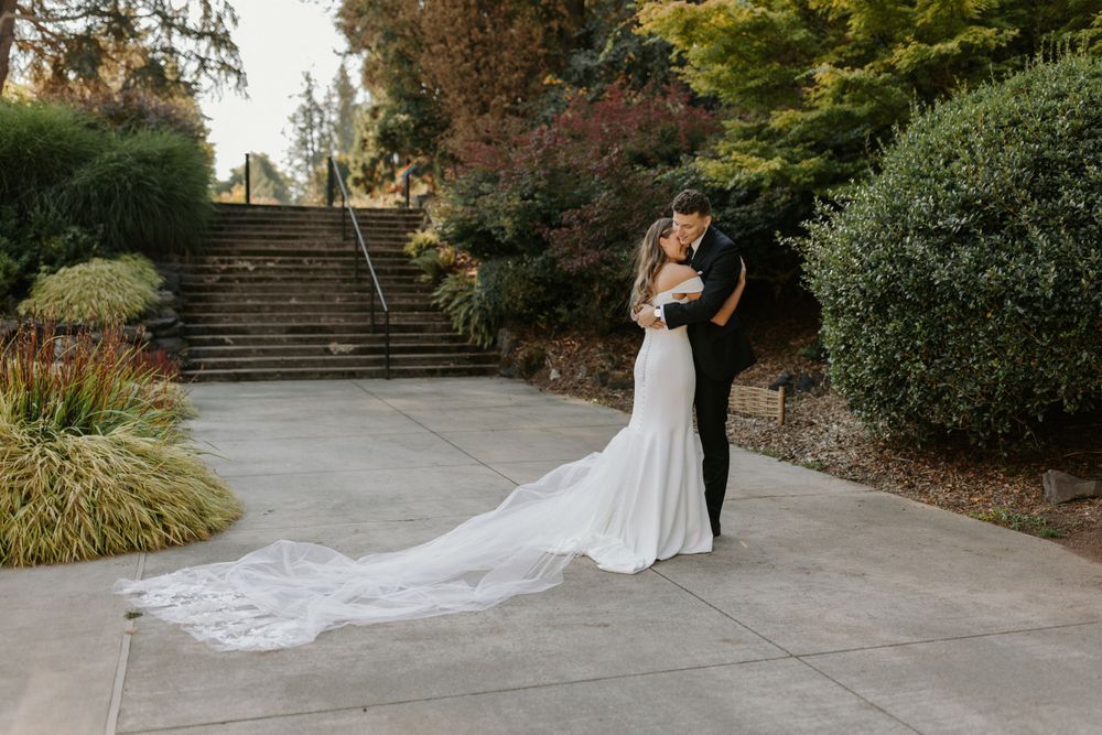 Married couple hugging by a staircase at Point Defiance Rose Garden in Tacoma