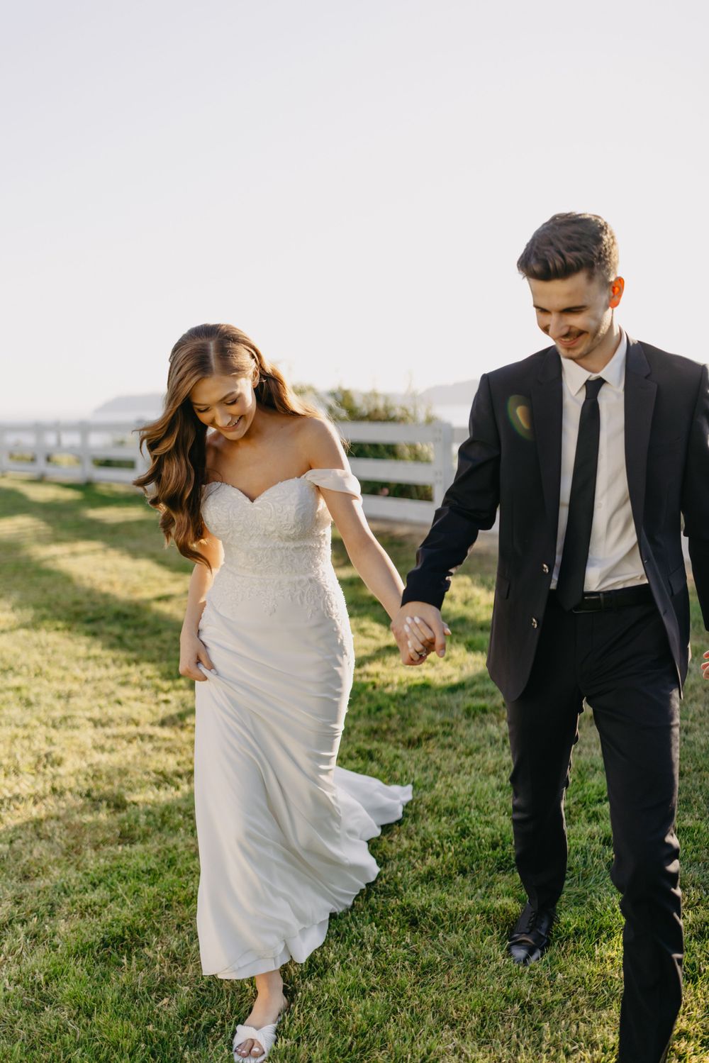 Bride and Groom walking next to the water at sunset in Mukilteo