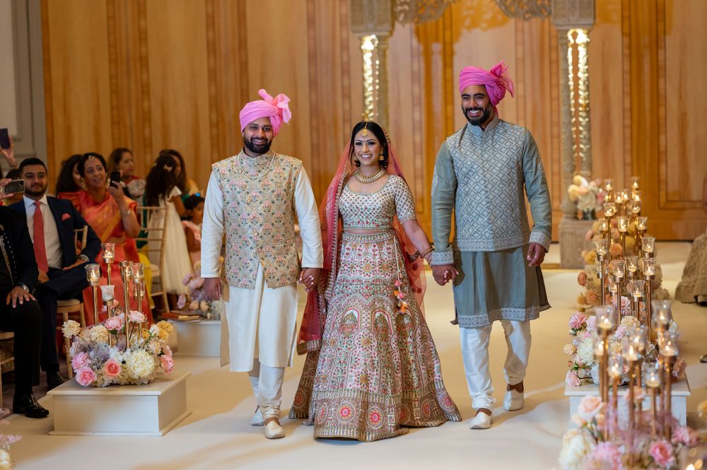 Elegant wedding ceremony setup with ornate gold decor and floral arrangements in a luxurious indoor venue.