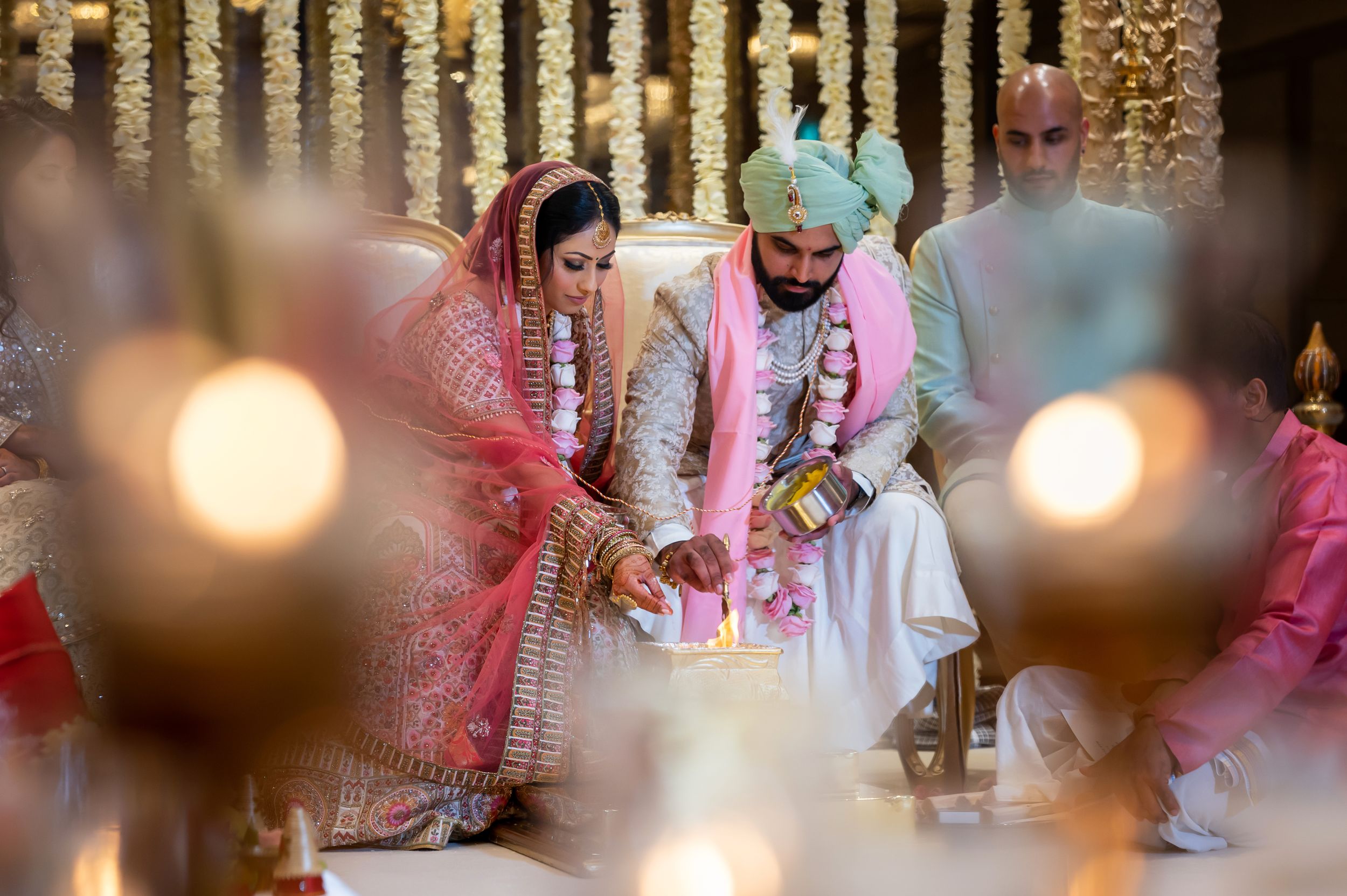 Romantic wedding ceremony space with hanging crystal decorations and soft lighting creating an intimate atmosphere.