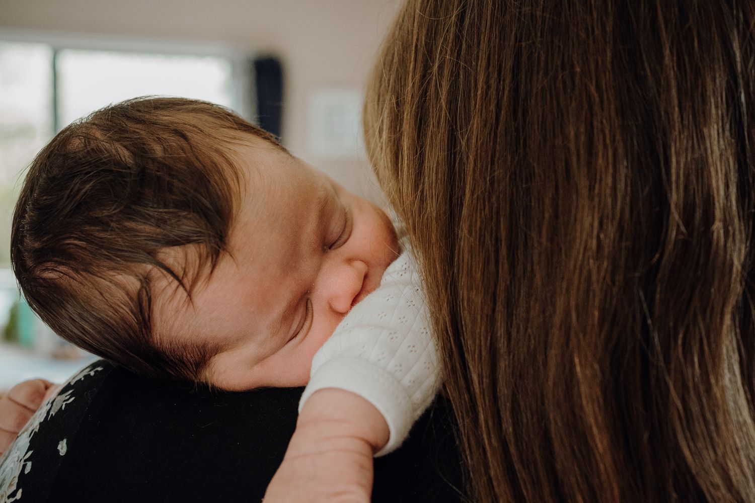 Little squish on the shoulder of mum at home.