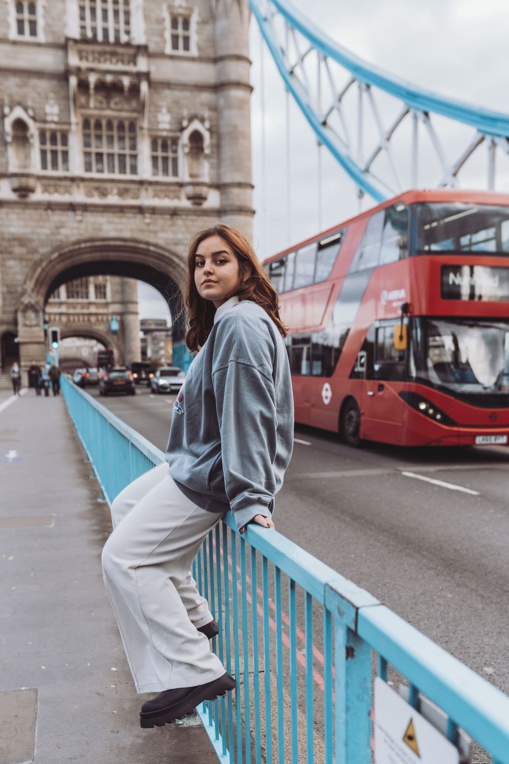 A girl sitting on the Tower bridge in London photoshoot