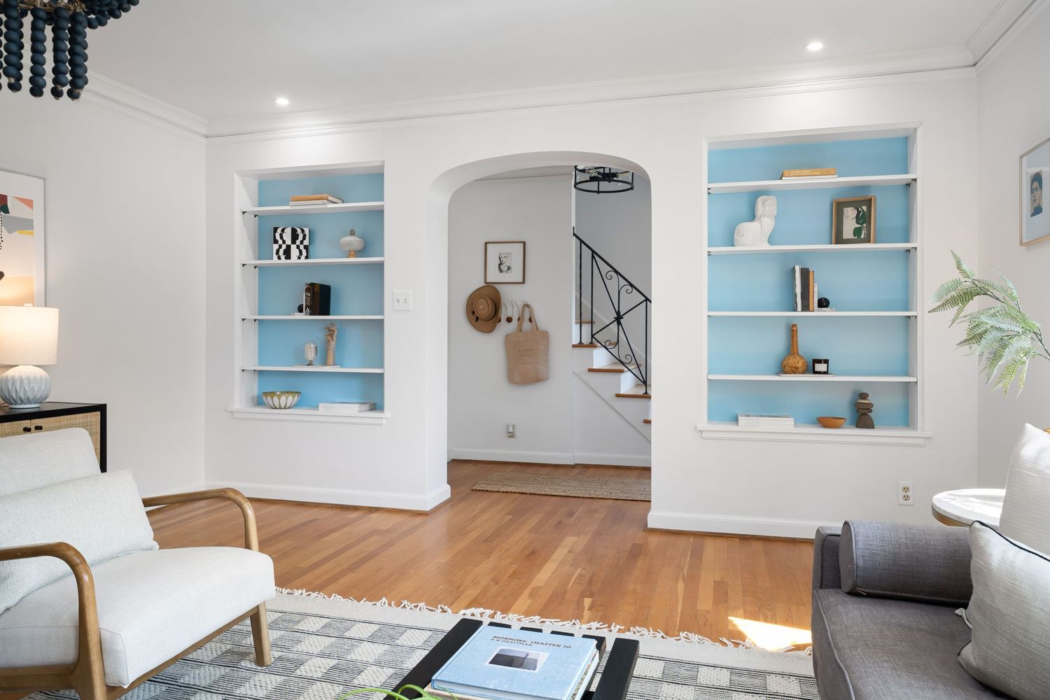 Editorial style photo composition showing blue bookcases and Danish Modern furniture in a Grandview Ohio home.