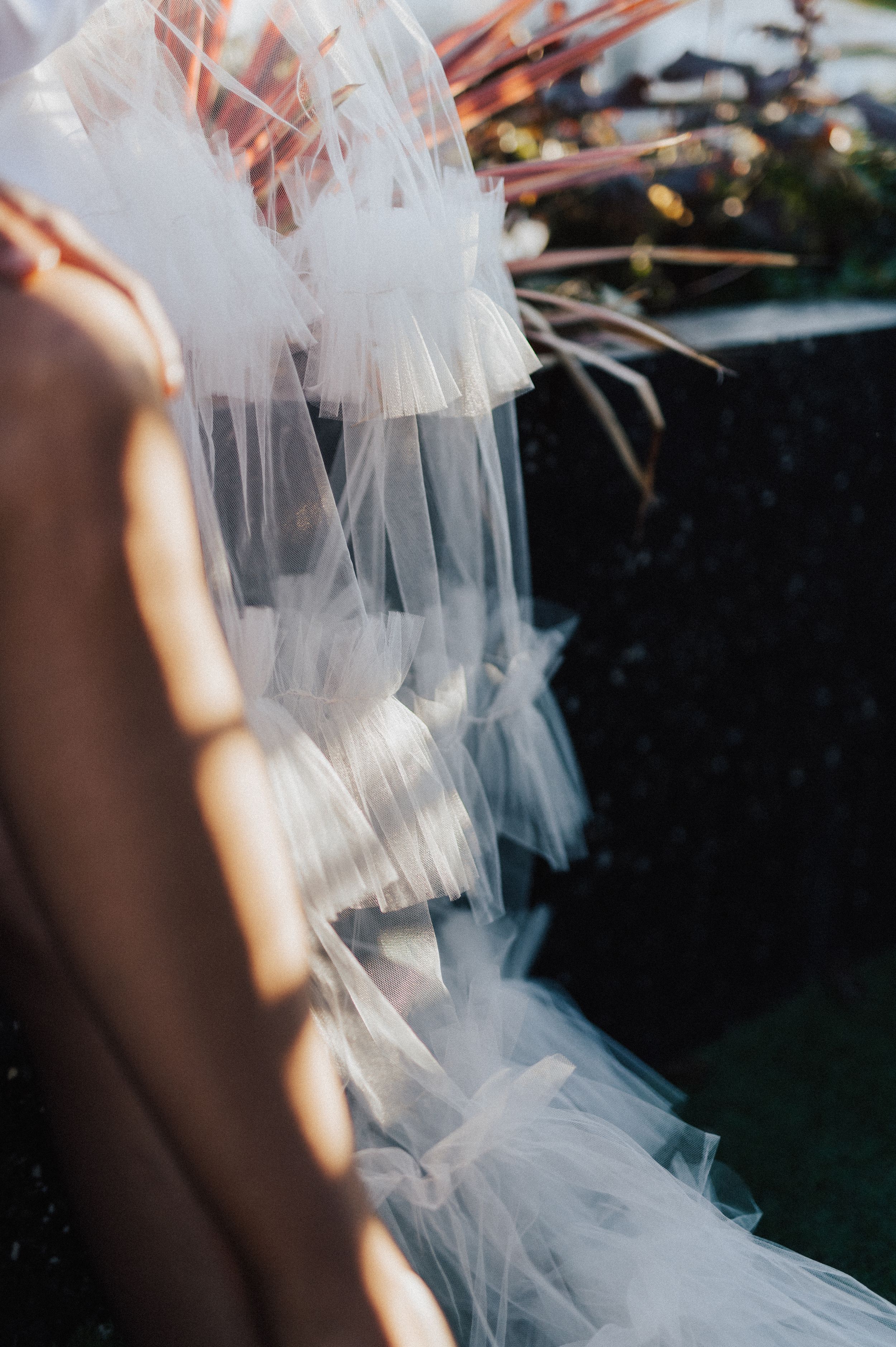 Ethereal bridal details showing flowing tulle fabric in natural light.