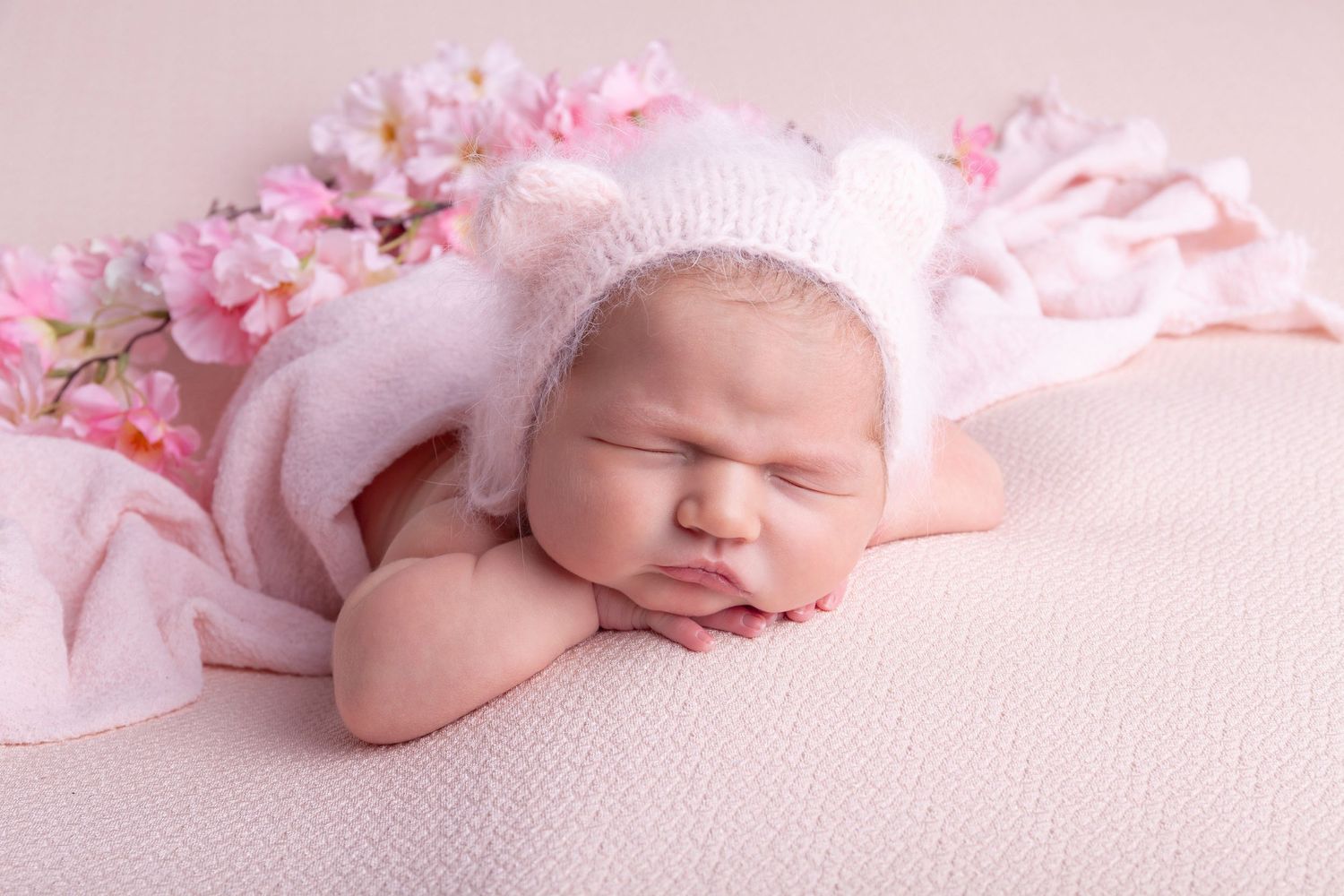 simple posed on baby's hand styled with flowera in a sleepy pose