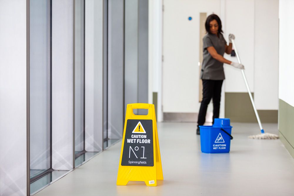 Office Cleaner mopping floor