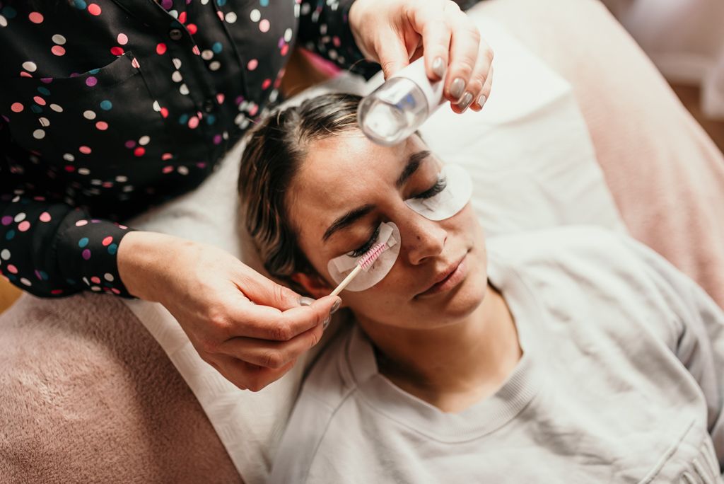 Person receiving a relaxing facial treatment with cotton pads.