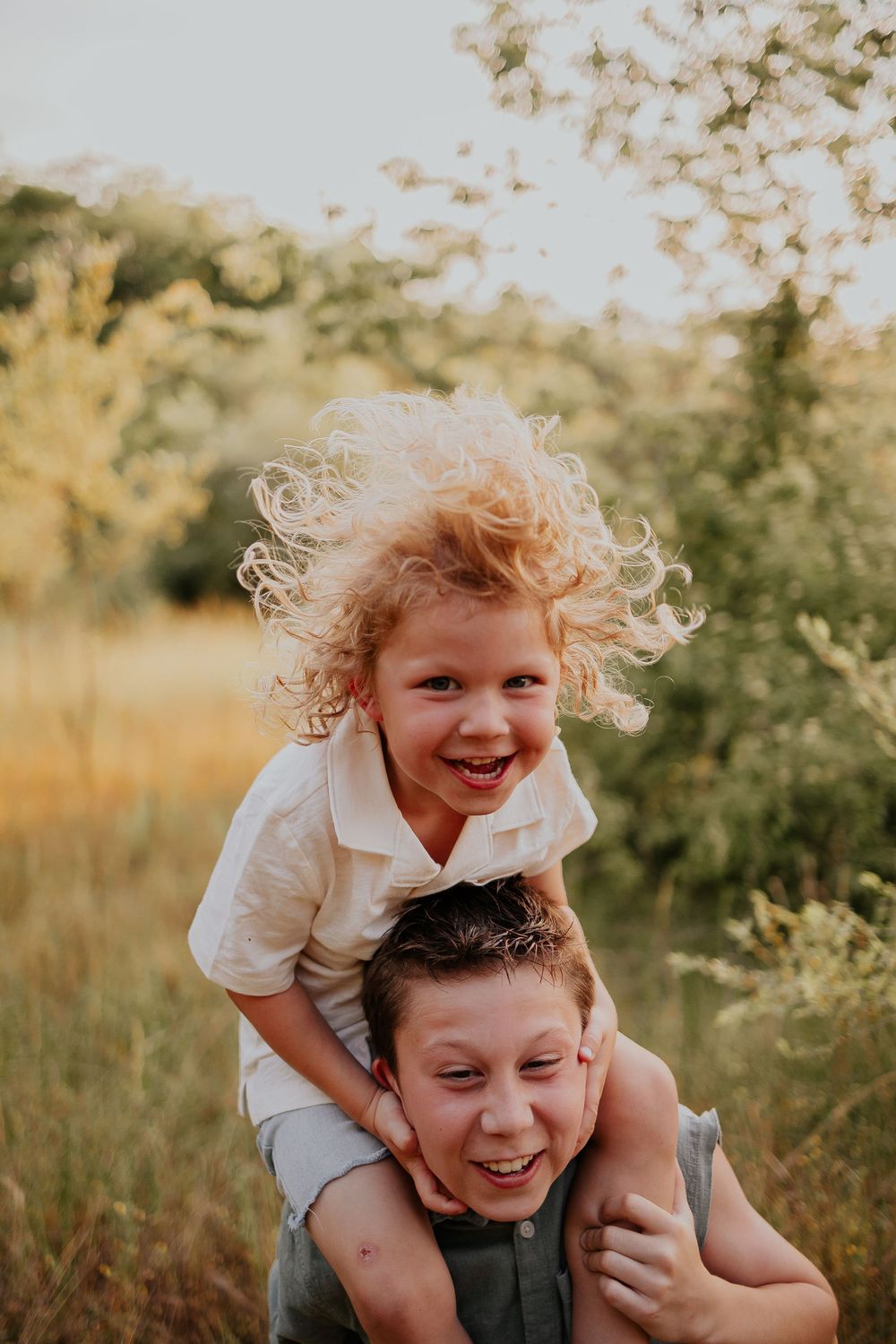 Candid outdoor photos show joyful parent-child bonding moments in a natural setting with warm lighting.